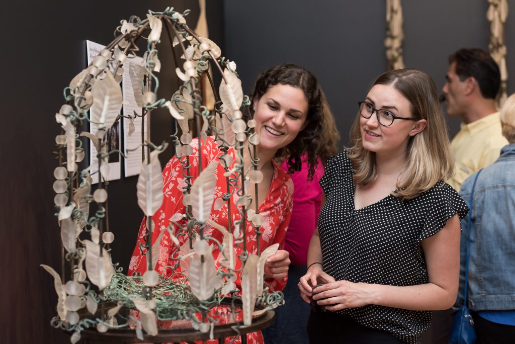 Guests admire work by Jenny Pohlman & Sabrina Knowles at a opening reception at BIMA.