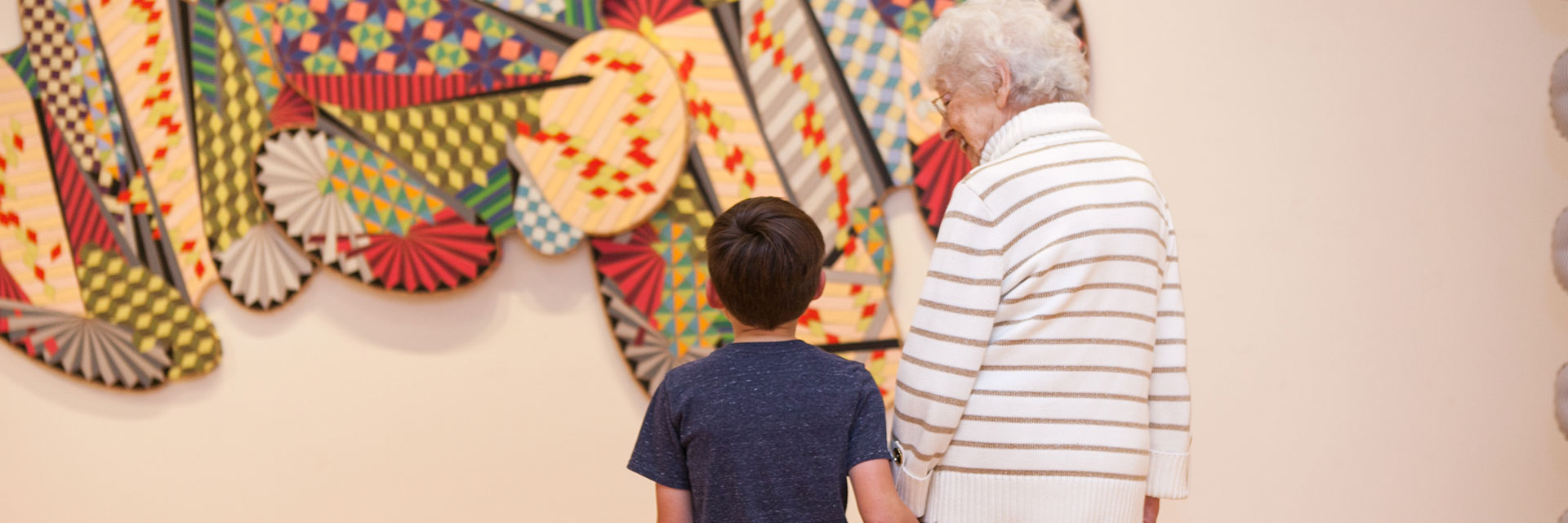 A young art fan takes in work with his great-grandmother at BIMA.