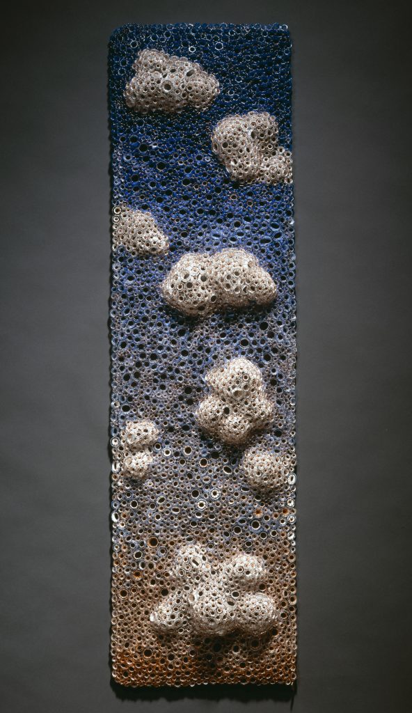 Kait Rhoads, Sunset, soft sculpture, 2008, blown glass, blue, orange and white hollow murrine woven with copper wire, with steel wall mount, 45.5”h x 13”w x 3”d.