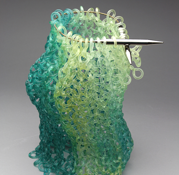 Carol Milne, Wiggle Room, 2017, kiln cast lead crystal and Addi click knitting needles, 14h x 10w x 10d inches, Courtesy of the Artist