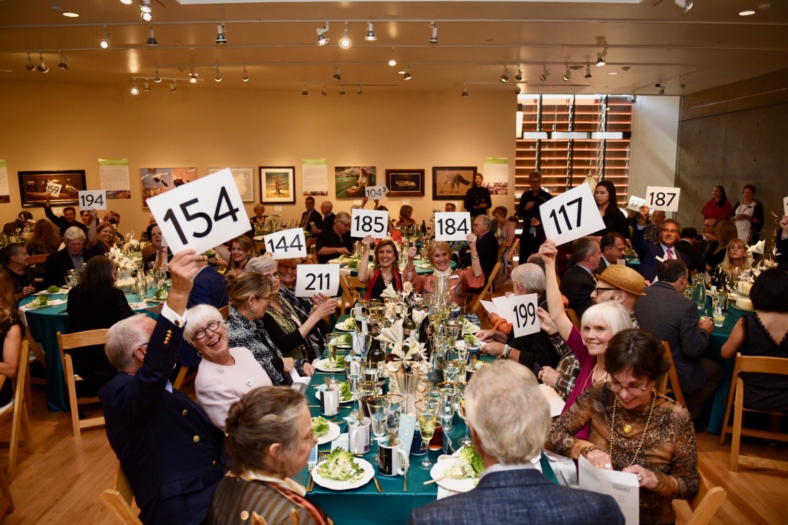 BIMA Bash 2019 Saturday raising their bid cards in support of Bainbridge Island Museum of Art.