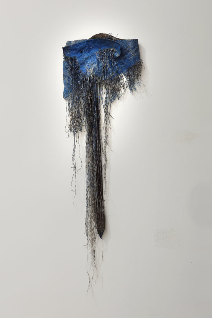 Gail Grinell (Seattle), untitled tarp, 2019, found woven plastic tarp, nail, corsage pin, Courtesy of the Artist, photo credit Mark Woods