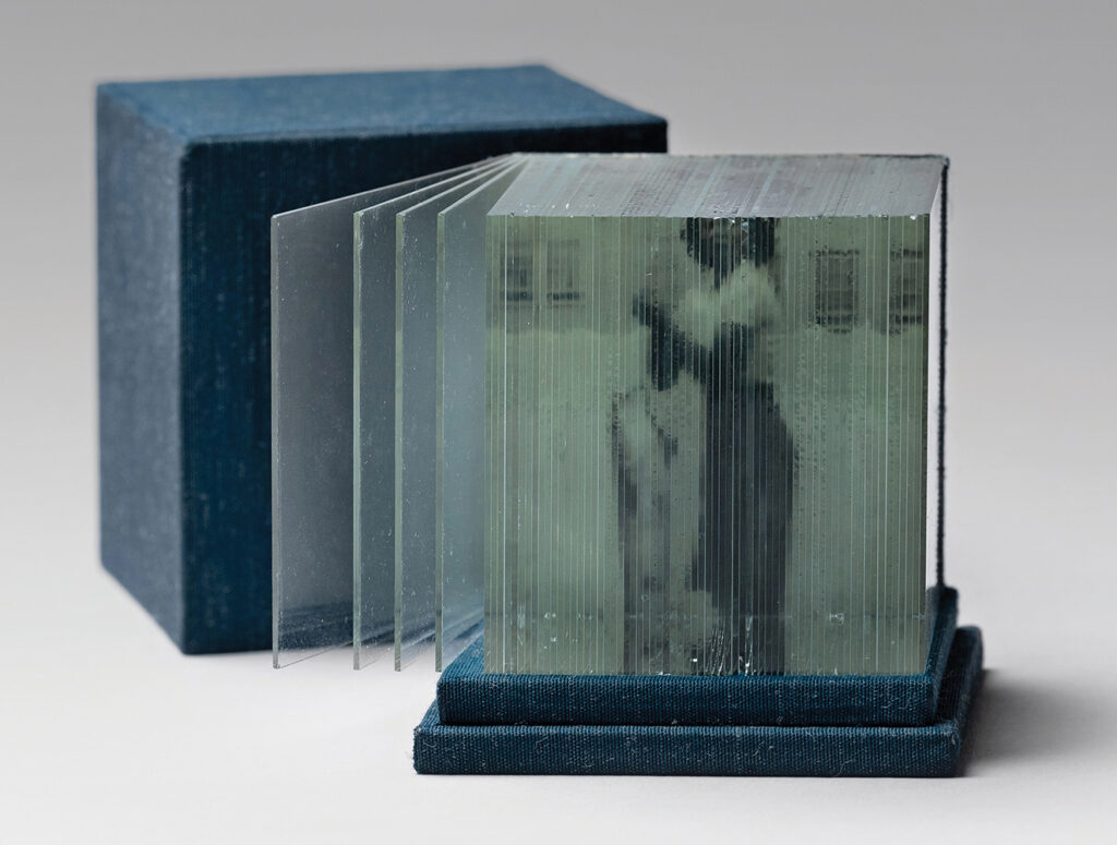 Roberta Lavadour (Pendleton, OR), Relative Memory, 2007, photo print on cloth spine of glass pages, fabric-wrapped box and lid, box: 3.75”h x 2.875”w x 2.875”d; book: 2.5”sq., unique, Cynthia Sears Artist's Books Collection, photo by Hunter Stroud