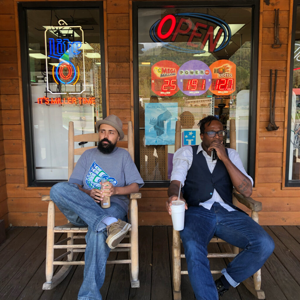 Khingz and Gabriel Teodros from Abyssinian Creole sitting on a porch.