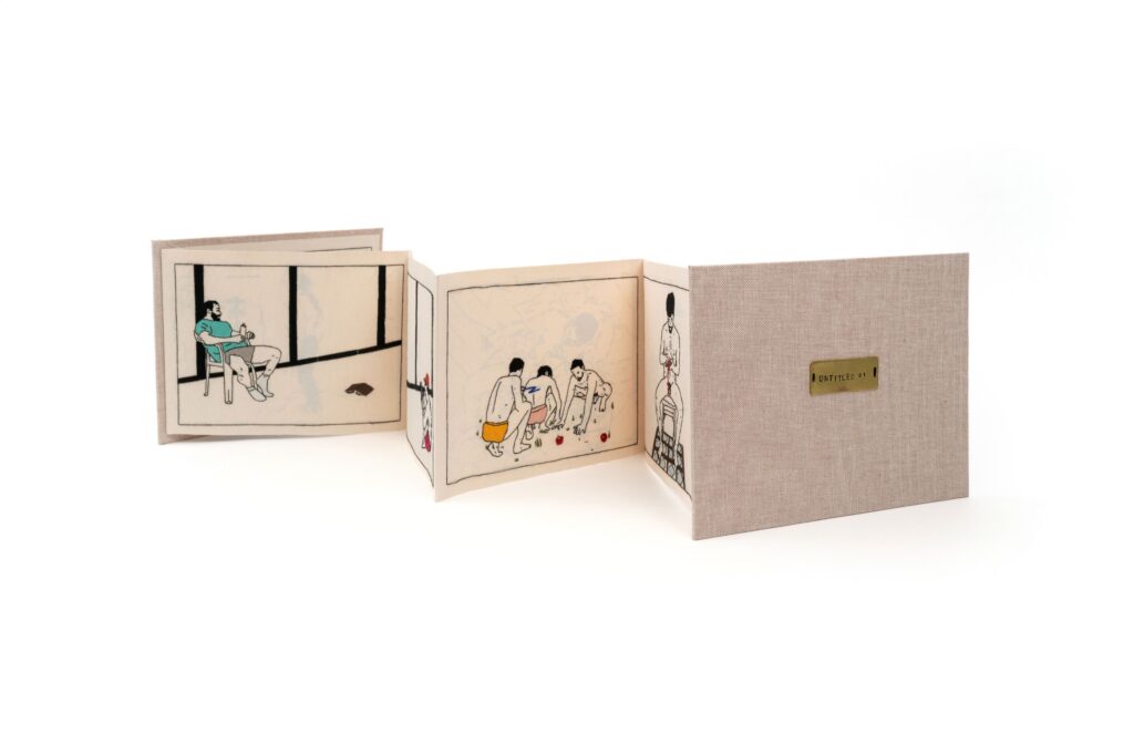 A white accordion book is standing up and unfolded with drawn images of people on the pages